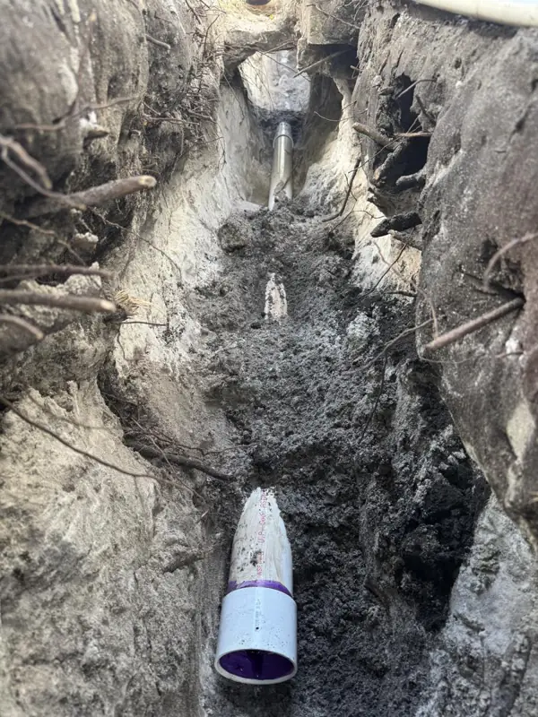 Sewer line replacement, during: Old line dug out and tied into new PVC