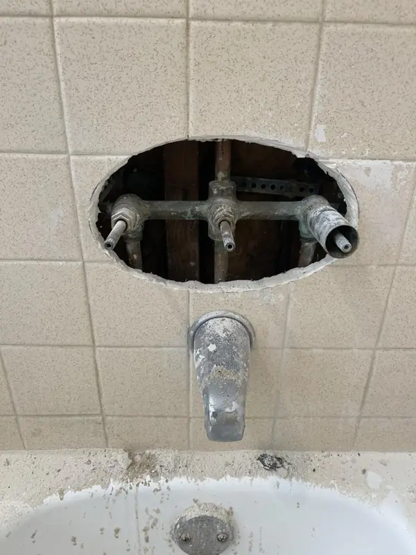 Tub and shower valve replacement, during: Wall opened up